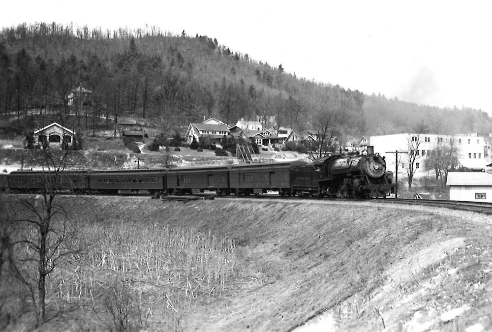 A black and white photo of Clinchfield 4-6-2 No. 154 turning a corner on the tracks