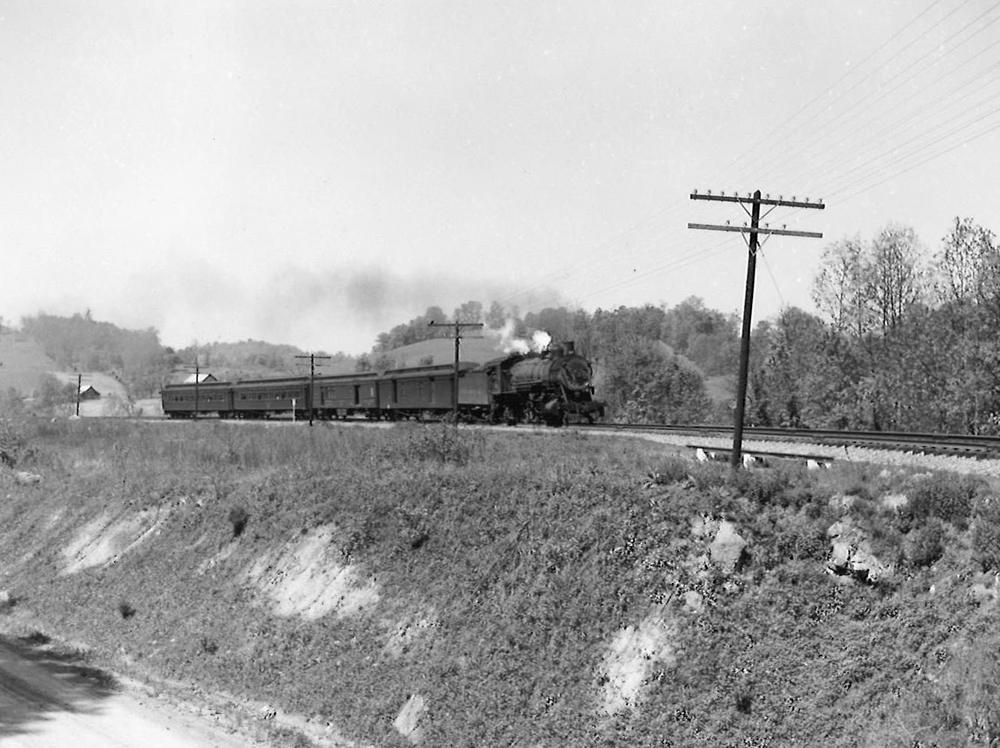 A black and white photo of the Clinchfield Railroad 4-6-2 coming down the tracks on a raised track