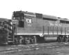 A close up black and white picture of a GP30 diesel locomotive parked in a rail yard