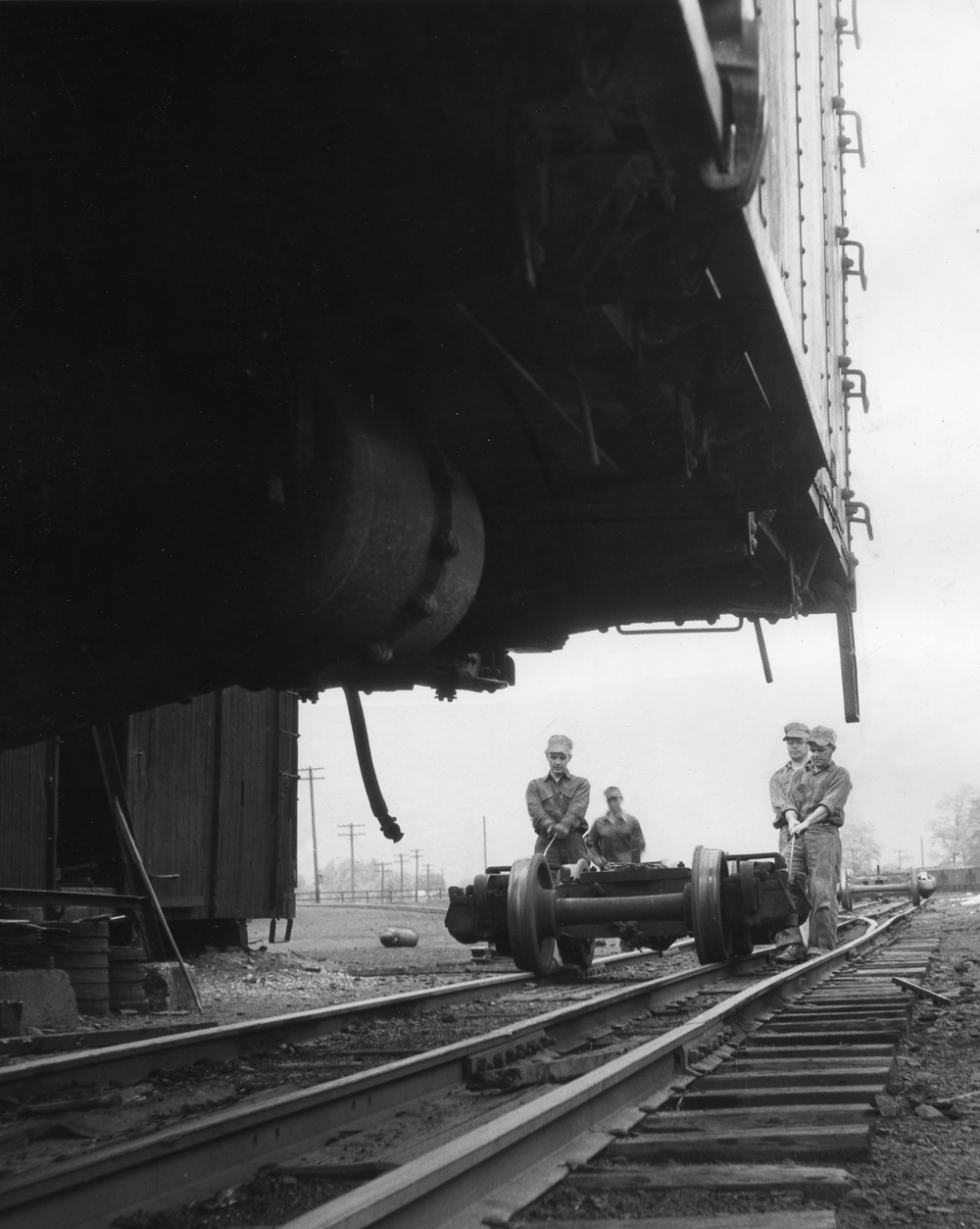 Four people making repairs to a train
