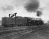 A man standing on top of a parked train