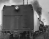The back of a train moving on the tracks