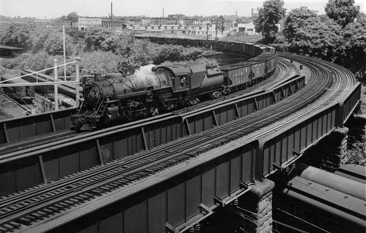 Steam-powered freight on sharp curved bridge