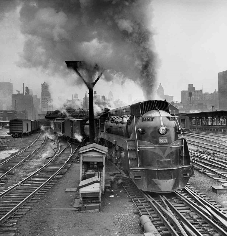 a streamliner engine pulling passenger cars