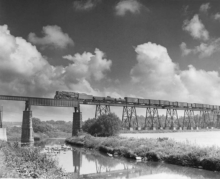 Steam powered freight on high viaduct