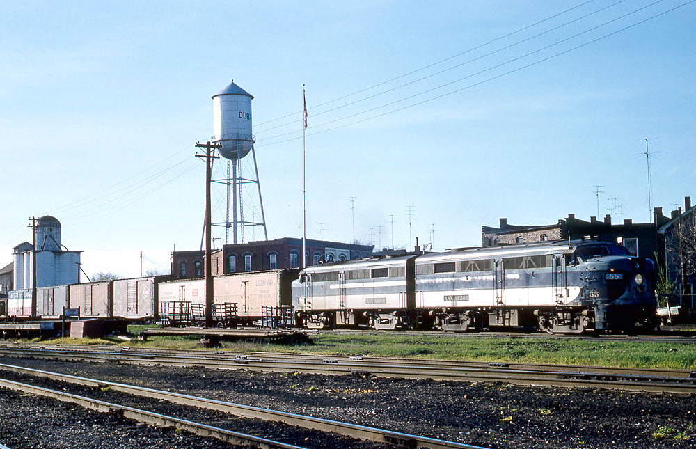 Two cab-style diesel locomotives with freight train