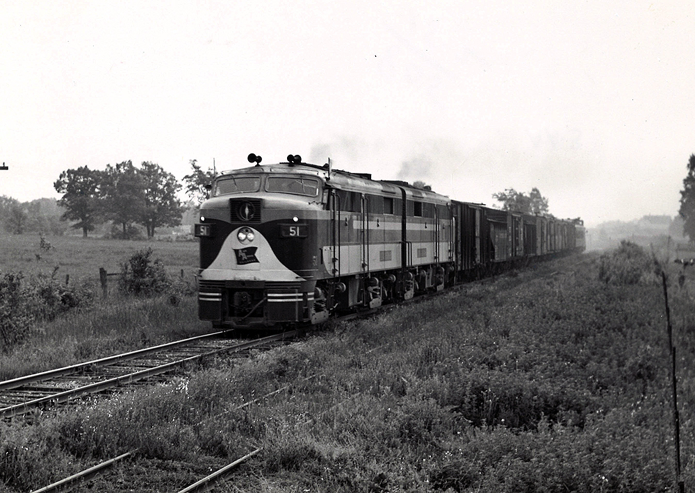 Two cab-style diesel locomotives with freight train