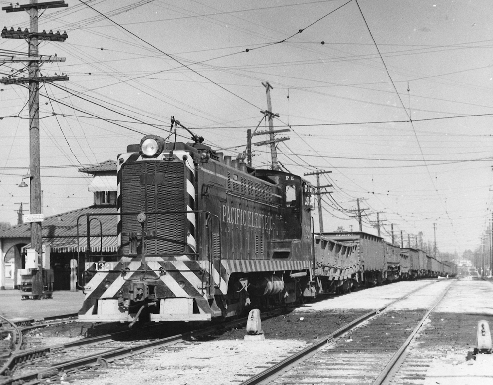 A small diesel locomotive leads a train.
