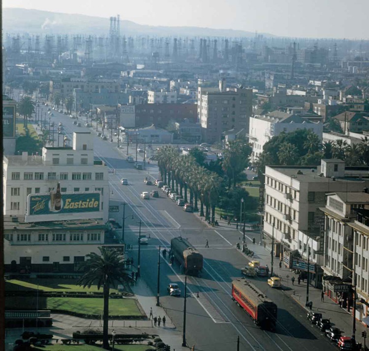 Bird's eye view of two streetcars meeting on a city street in a color photograph.