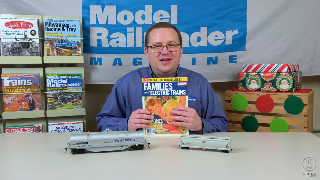 Cody Grivno holding a copy of CTT special issue Families and Electric Trains
