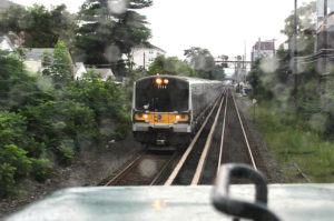 An outbound Long Island Rail Road train meets a New York & Atlantic train on a section of the LIRR Main Line.