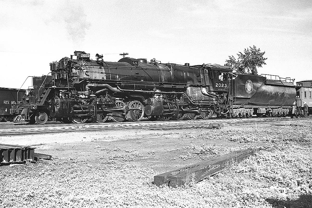 An articulated steam locomotive in a rail yard.