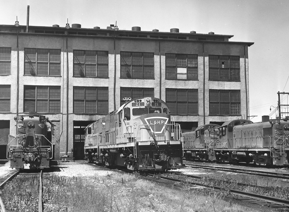 Lehigh & Hudson River diesel locomotives outside shop building.