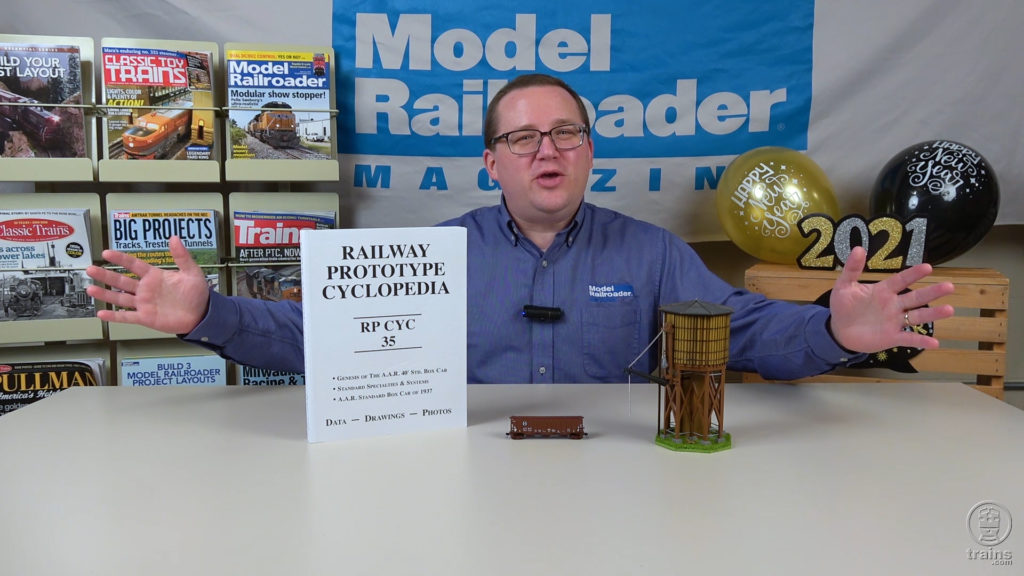 Cody sitting at a desk with new model train products