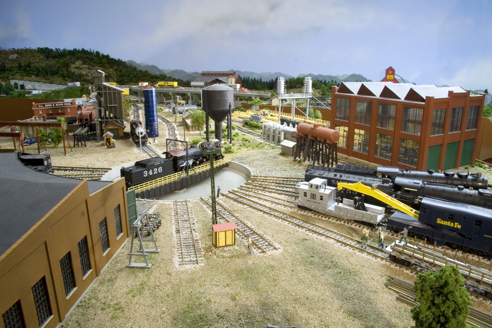 An HO Scale Santa Fe yard with roundhouse, turntable, and diesel engine shed.