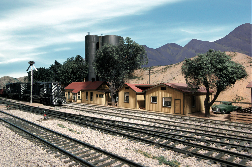 Second-generation diesel locomotives pose in front of a depot — a main thoroughfare for the Santa Fe in the steam-to-diesel transition era.