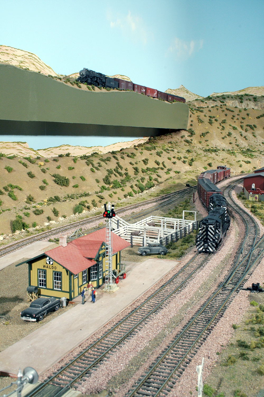 Vertical image combines two Santa Fe scenes on a double-deck layout as it might have appeared in New Mexico.