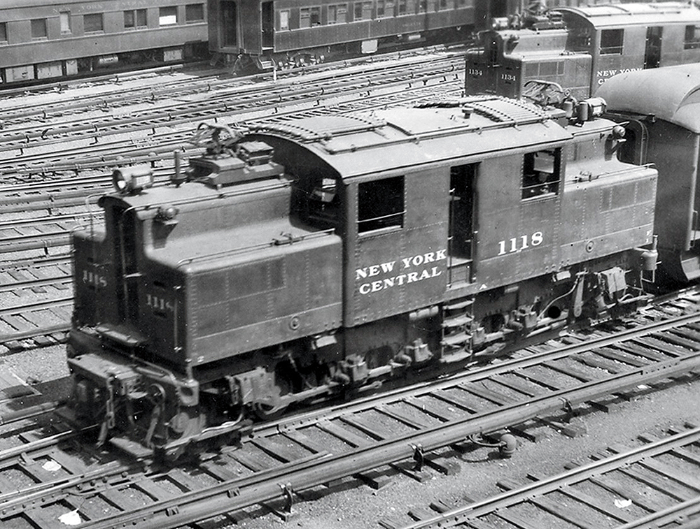 An oblique overhead view of an electric locomotive in a rail yard.