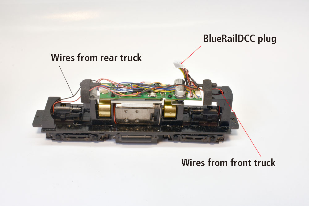 Walthers H10-44 chassis, green SoundTraxx DCC decoder mounted above motor on black die-cast metal frame, white four-wire for BlueRailDCC board sticking up