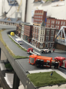 A truck sitting on its side in the middle of the road