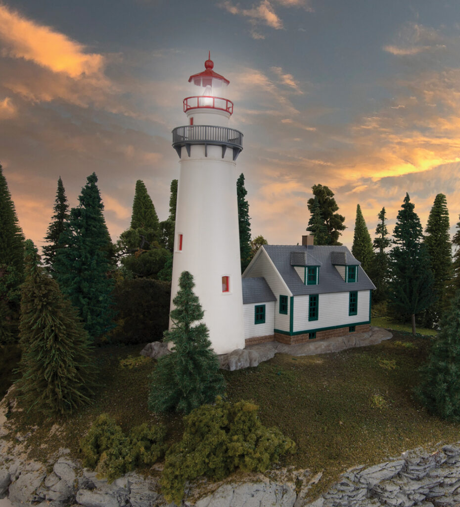Model lighthouse surrounded by trees