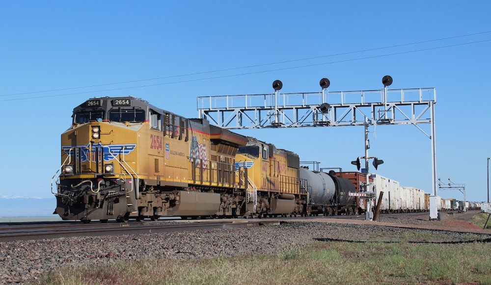 Train passing under signal bridge