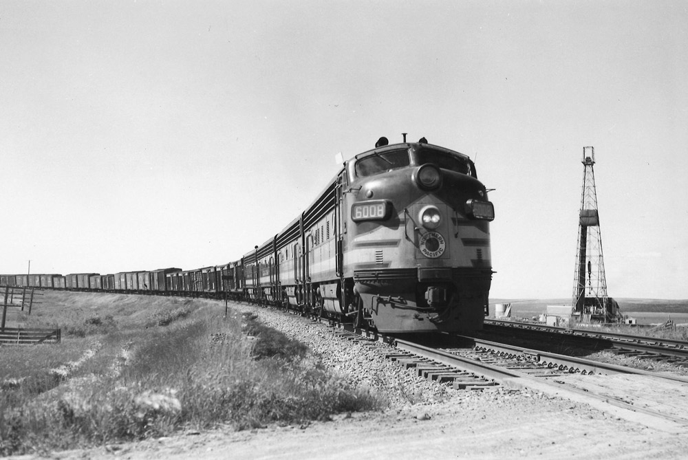 Streamlined diesel locomotives on freight train.