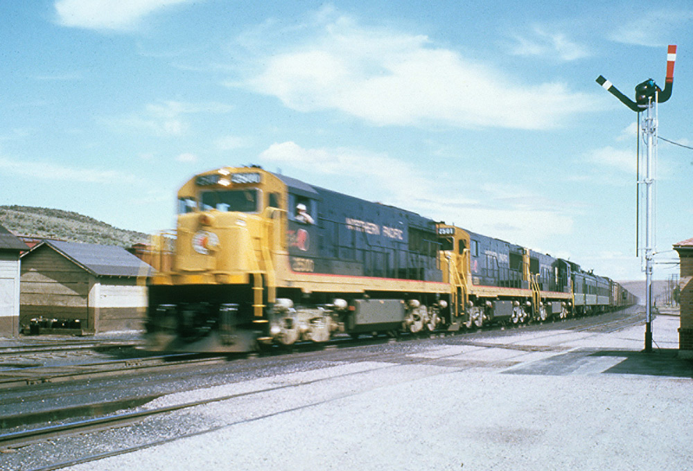 Road-switcher diesel locomotives with freight train.