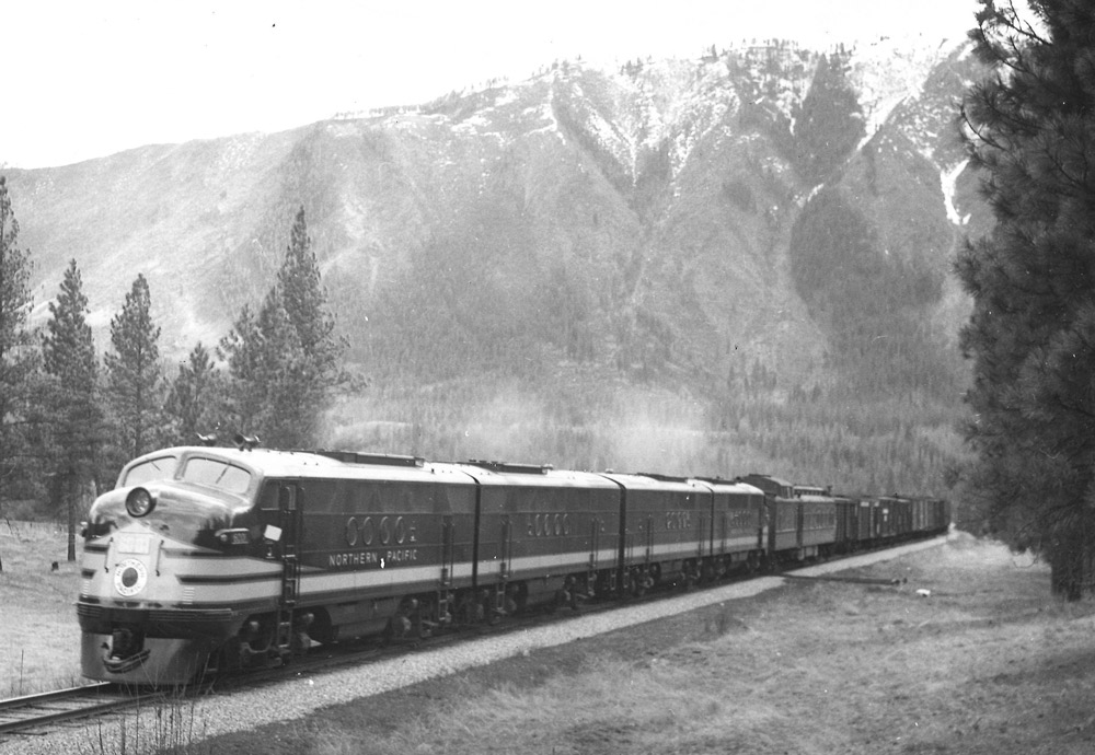 Streamlined diesel locomotives with freight train.