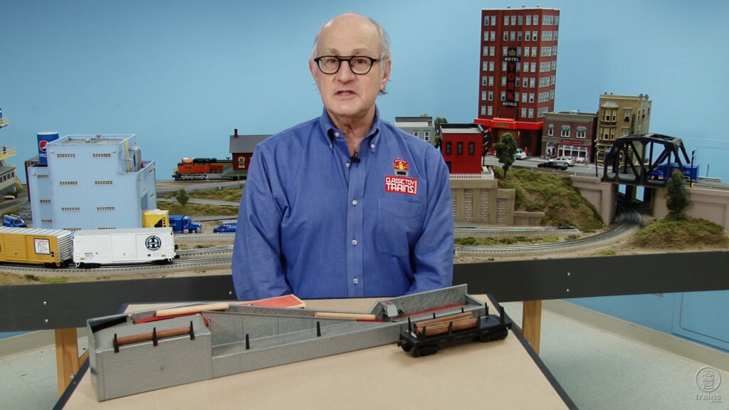 Roger Carp next to a log loader accessory