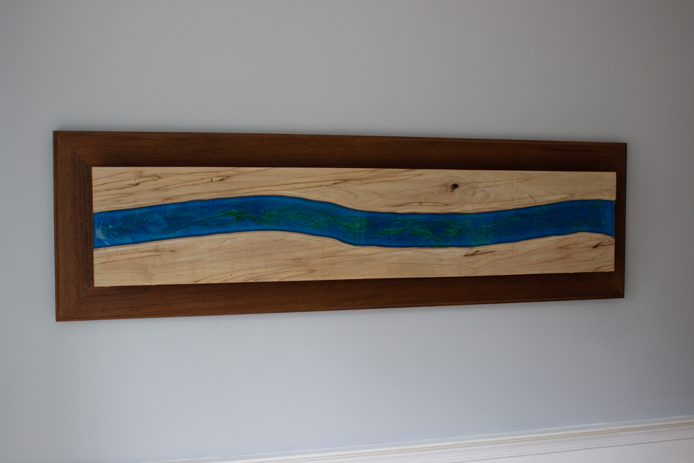 A hanging piece of wavy resin wall art.