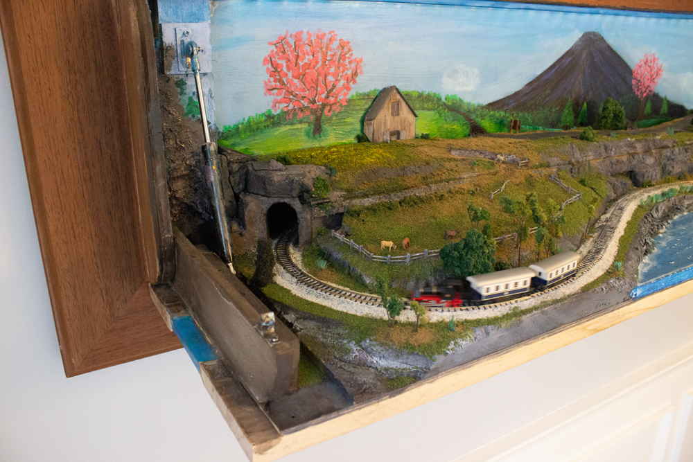 A train passes in front of a farm pasture