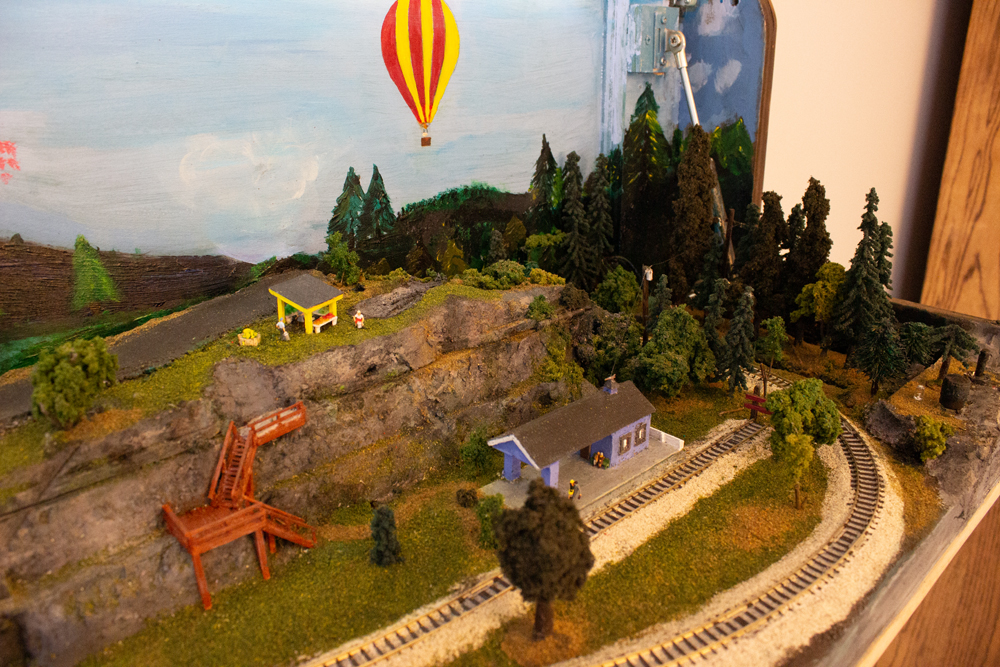 A train station sits at the bottom of a hill.