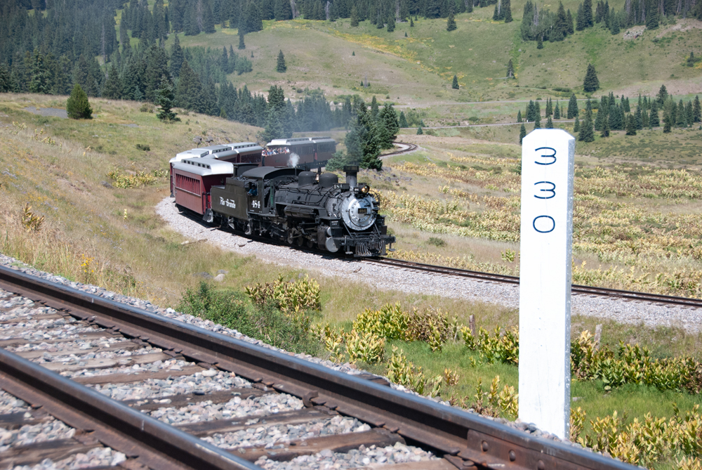 Train snakes through S curve with another track in foreground