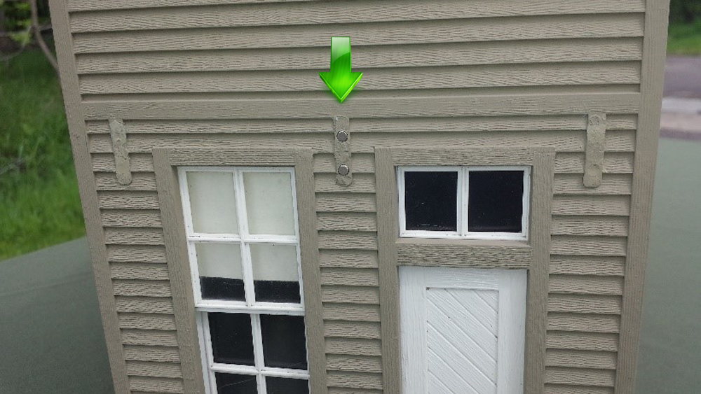 Front of a model structure with arrow pointing to magnets