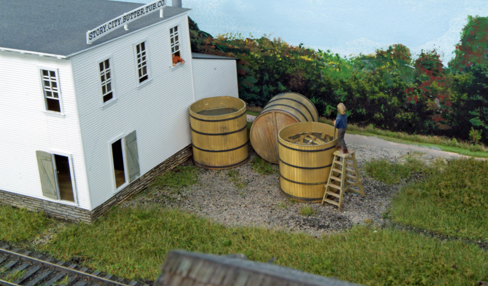 Figure next to model wood barrel
