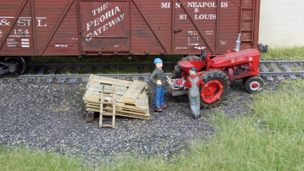 Model figures next to grain elevator