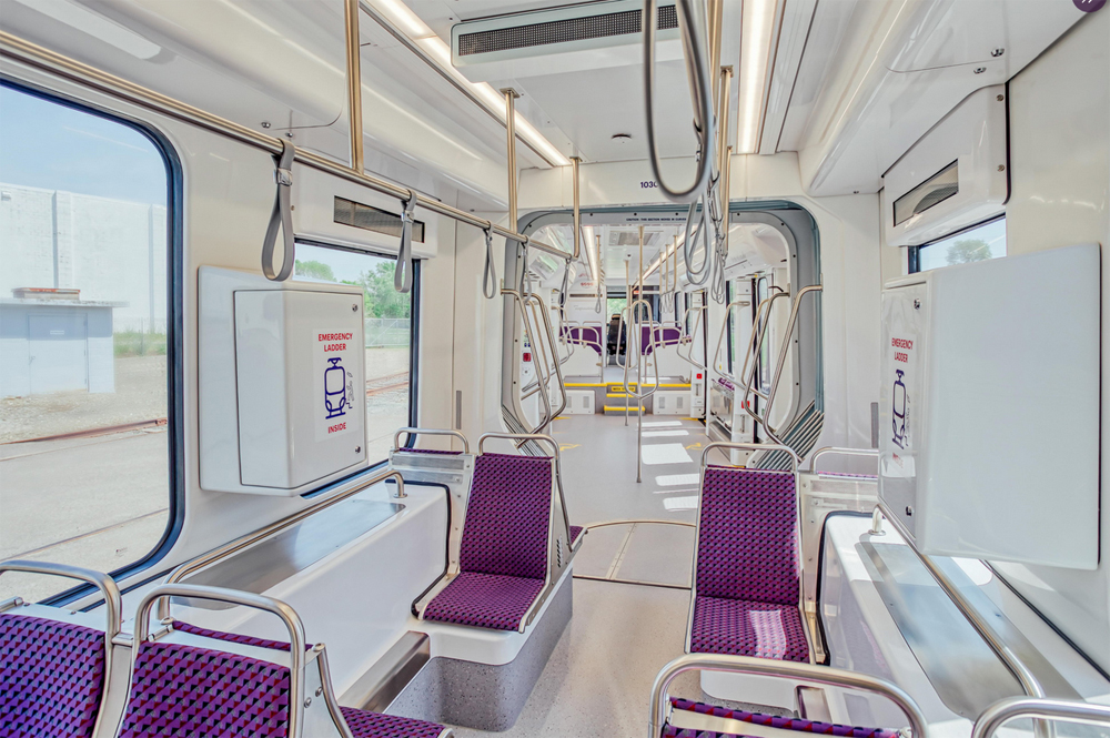 White interior of light rail car with purple seats