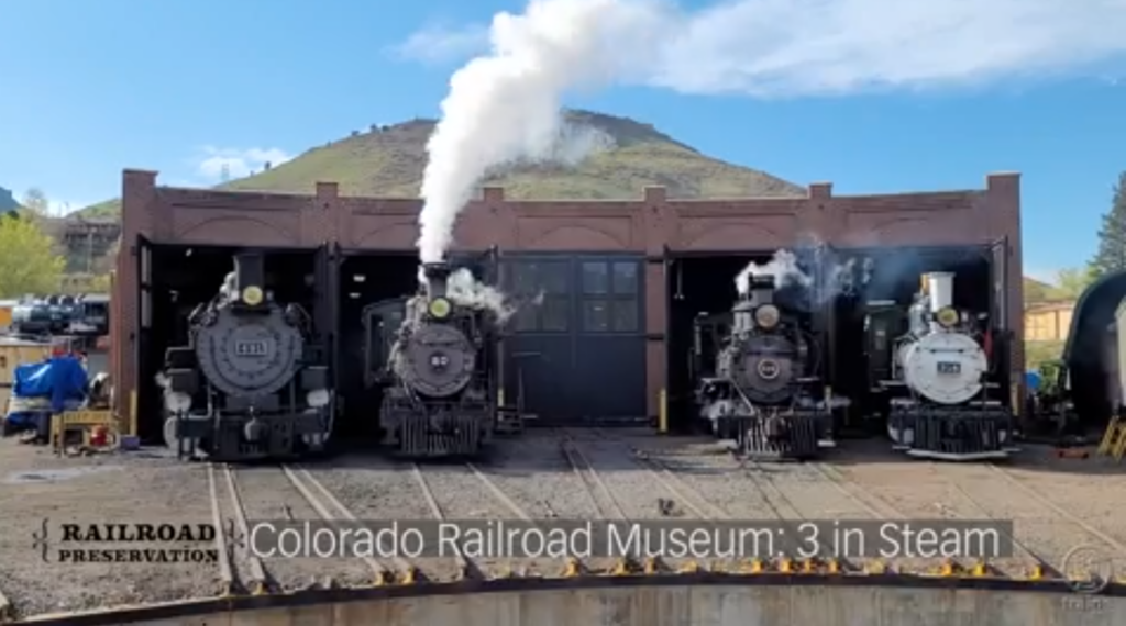 Four locomotives in a roundhouse