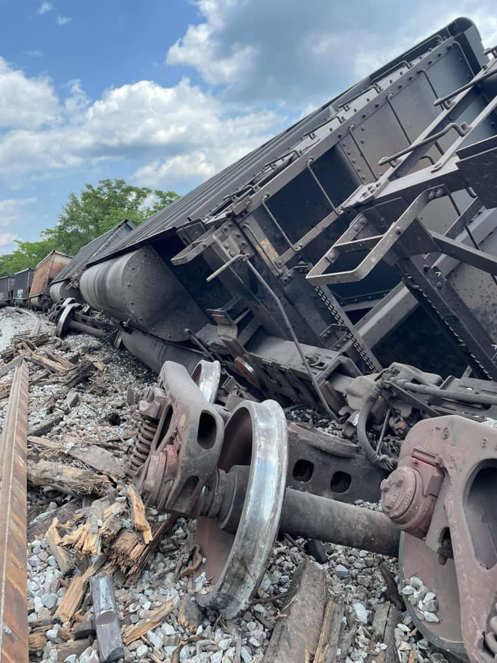 Coal hopper on its side with wheelset in foreground