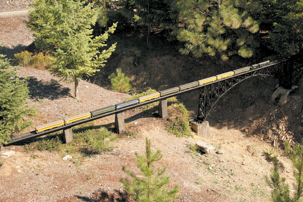 Model passenger train on bridge