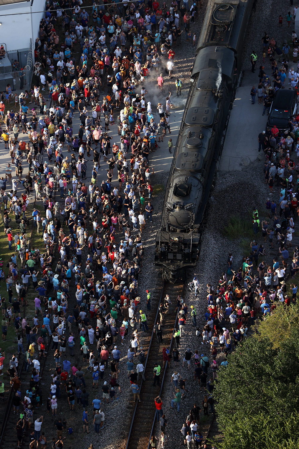 Close up overhead image of Big Boy surrounded by people at a stop.