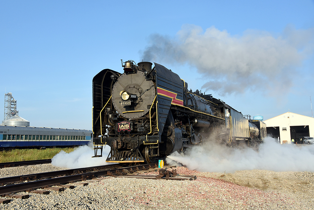 Close-up view of a steam locomotive in a yard.