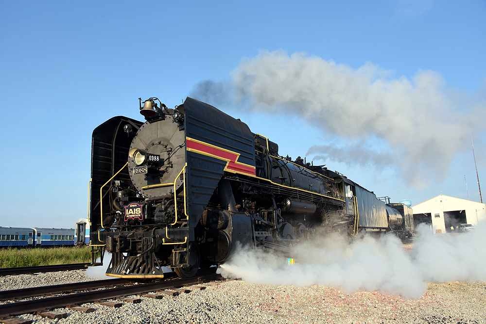 Close-up view of a steam locomotive in a yard.