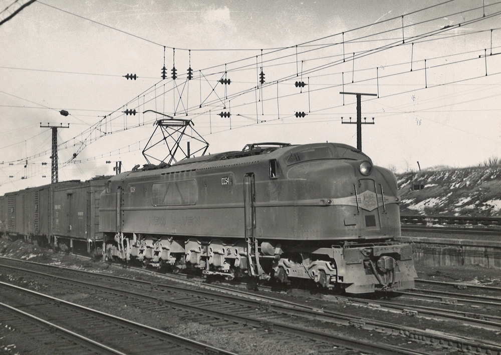 Black-and-white three-quarter-angle photo of streamlined electric locomotive.