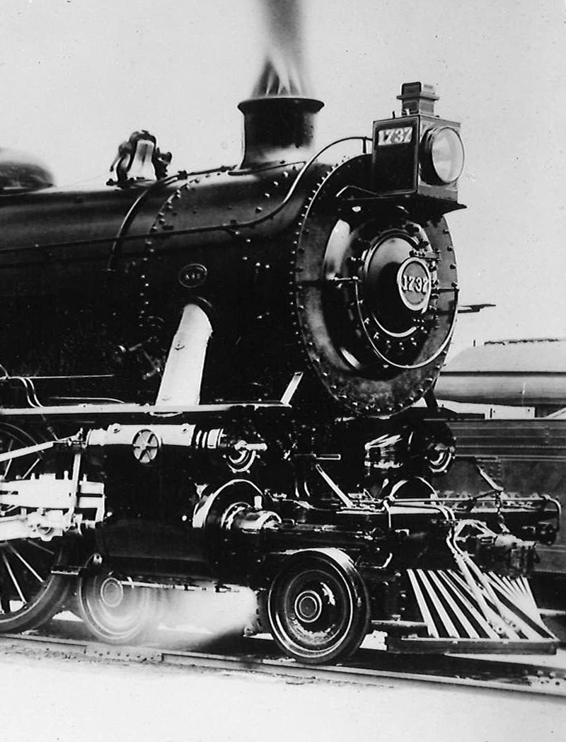 Black-and-white photo of front portion of 4-6-2 steam locomotive 