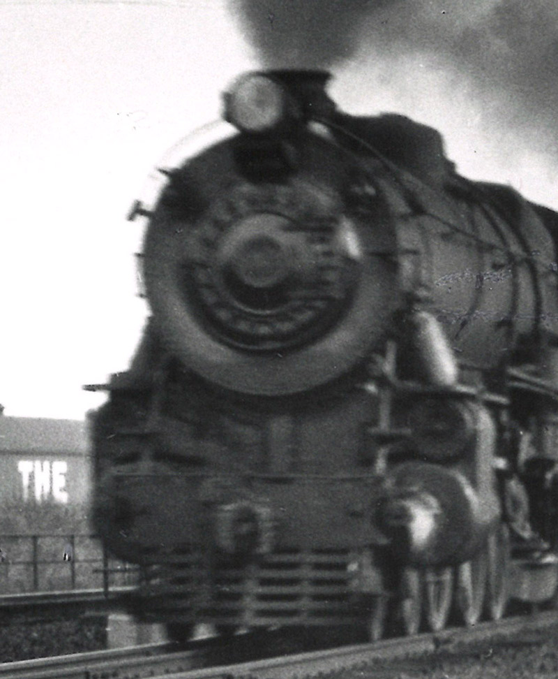Black-and-white photo of front portion of 4-6-2 steam locomotive.
