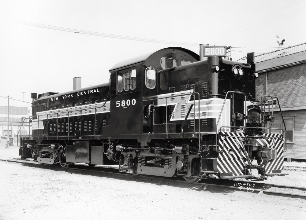 Black-and-white three-quarter-angle photo of road-switcher diesel locomotive .