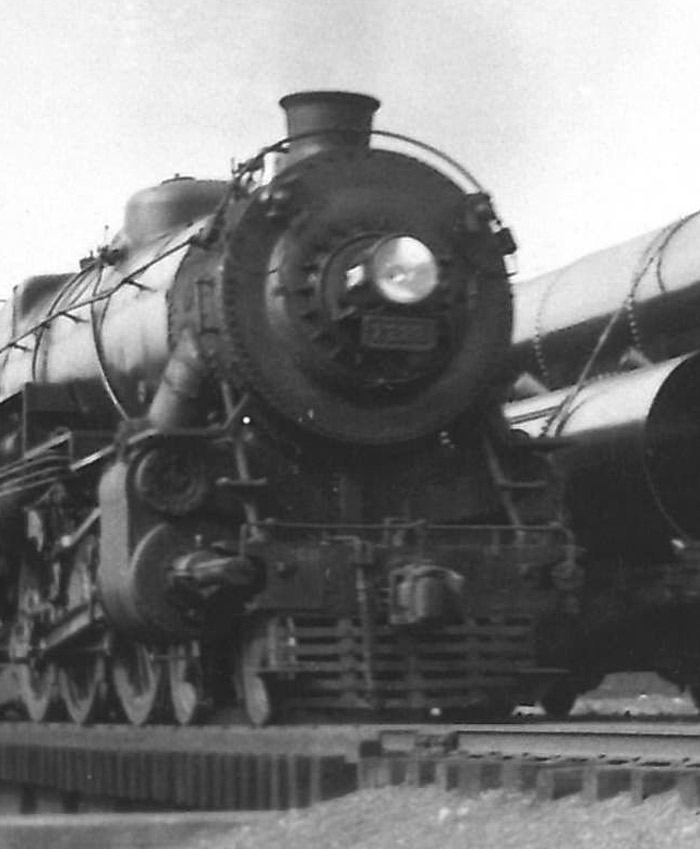 Black-and-white photo of front portion of 4-6-2 steam locomotive.