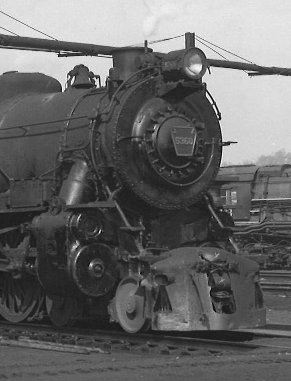 Black-and-white photo of front portion of 4-6-2 steam locomotive.